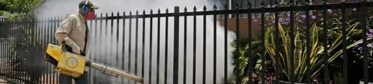 Mosquito control technician fogging a yard perimeter for mosquito reduction in Arvada, CO